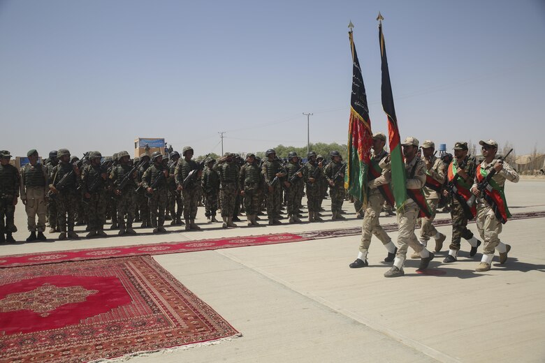 The Afghan National Army 215th Corps color guard marches the Afghan national colors during a graduation ceremony at Camp Shorabak, Afghanistan, July 24, 2017.  Approximately 600 soldiers with 2nd Kandak, 4th Brigade, 215th Corps completed an eight-week operational readiness cycle at the Helmand Province Regional Military Training Center with assistance from U.S. Marine advisors assigned to Task Force Southwest. Throughout the course, the soldiers learned infantry tactics and weapons techniques in order to enhance their warfighting capabilities. (U.S. Marine Corps photo by Sgt. Lucas Hopkins)