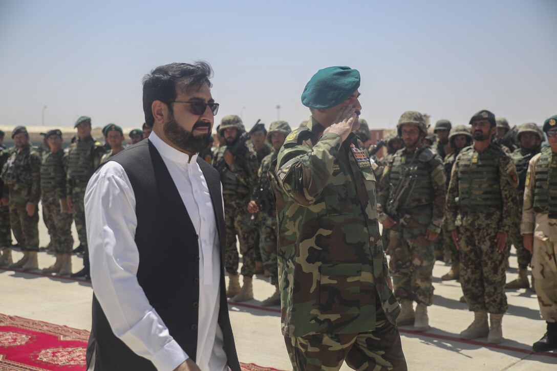 Hayatullah Hayat, left, the governor of Helmand Province, and Afghan National Army Brig. Gen. Wali Mohammed Ahmadzai, right, the commanding general of 215th Corps, greet soldiers with 2nd Kandak, 4th Brigade, 215th Corps during a graduation ceremony at Camp Shorabak, Afghanistan, July 24, 2017. Approximately 600 soldiers with the unit graduated from an eight-week operational readiness cycle July 24 with assistance from U.S. Marines assigned to Task Force Southwest. The ORC is designed to enhance the students’ warfighting capabilities to help defeat insurgency throughout the region. (U.S. Marine Corps photo by Sgt. Lucas Hopkins)