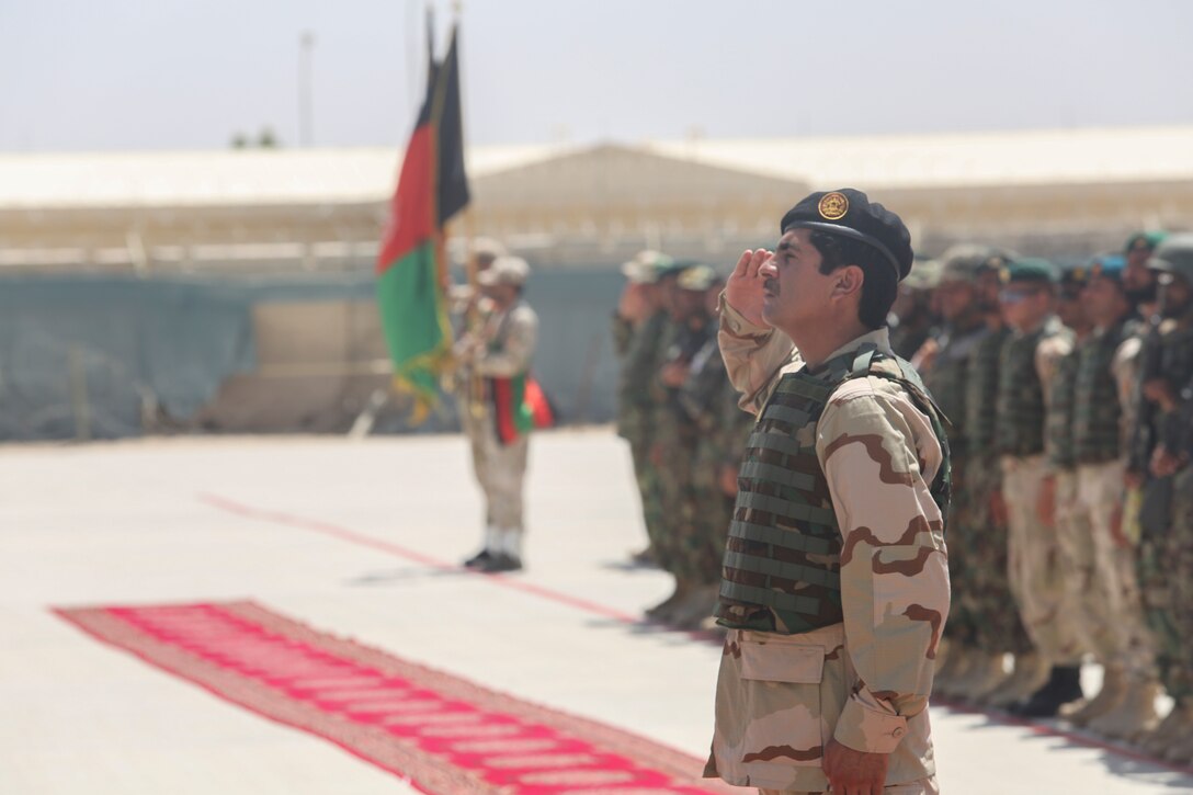 Afghan National Army Lt. Col. Mohibula, the commanding officer of 2nd Brigade, 4th Kandak, 215th Corps, salutes during the Afghan National Anthem during a graduation ceremony at Camp Shorabak, Afghanistan, July 24, 2017. The ceremony marked the conclusion of the unit’s operational readiness cycle, an eight-week training regimen designed to enhance the students’ warfighting capabilities. U.S. Marine advisors assigned to Task Force Southwest assisted ANA instructors throughout the course, using their experience to develop the soldiers into highly-trained infantrymen. (U.S. Marine Corps photo by Sgt. Lucas Hopkins)