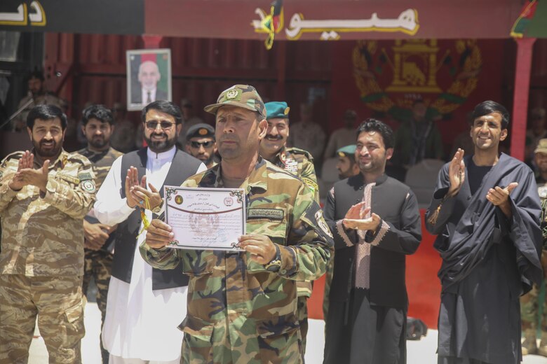 An Afghan National Army soldier with 2nd Kandak, 4th Brigade, 215th Corps presents his graduation certificate from an operational readiness cycle at Camp Shorabak, Afghanistan, July 24, 2017. Approximately 600 soldiers with the unit graduated from the eight-week training program, which focused on improving the 2nd Kandak, 4th Brigade’s warfighting abilities in order to combat insurgency throughout Helmand Province. (U.S. Marine Corps photo by Sgt. Lucas Hopkins)