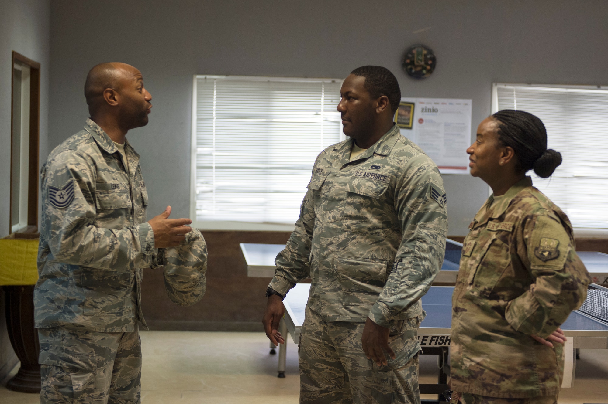 U.S. Air Force Senior Airman Quae Hayes, center, an analyst with the 379th Expeditionary Maintenance Group, listens to Tech. Sgt. Jermaine Lewis, a quality assurance evaluator with the 379th Expeditionary Forces Support Squadron, talk about the services that EFSS provides at Al Udeid Air Base, Qatar, July 14, 2017.  Hayes is taking part in a Chief Shadowing Program and was paired up with Chief Master Sgt. Gloria Weatherspoon, right, a chief enlisted manager with the 379th EFSS, for the day in order to receive a glimpse into the day-to-day actives of a Chief Master Sgt. in the U.S. Air Force. (U.S. Air Force photo by Tech. Sgt. Amy M. Lovgren)