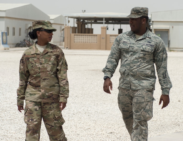 U.S. Air Force Senior Airman Quae Hayes, right, an analyst with the 379th Expeditionary Maintenance Group, talks with Chief Master Sgt. Gloria Weatherspoon, a chief enlisted manager with the 379th Expeditionary Forces Support Squadron at Al Udeid Air Base, Qatar, July 14, 2017.  Hayes is taking part in a Chief Shadowing Program and was paired up with Chief Master Sgt. Gloria Weatherspoon, right, a chief enlisted manager with the 379th EFSS, for the day in order to receive a glimpse into the day-to-day actives of a Chief Master Sgt. in the U.S. Air Force. (U.S. Air Force photo by Tech. Sgt. Amy M. Lovgren)