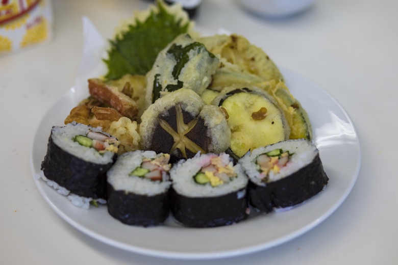 Sushi and Tempura sit on a plate after being cooked by Marine Corps Air Station Iwakuni residents at Santopia in Otake, Japan, July 25, 2017. The air station residents traveled with the Cultural Adaptation Program to partake in a Japanese cooking class where they learned to properly prepare and cook sushi, tempura and a Japanese pudding dessert. The class gave a common purpose for participants to work together and learn Japanese cooking skills that can be utilized within their own homes. (U.S. Marine Corps photo by Cpl. Joseph Abrego)
