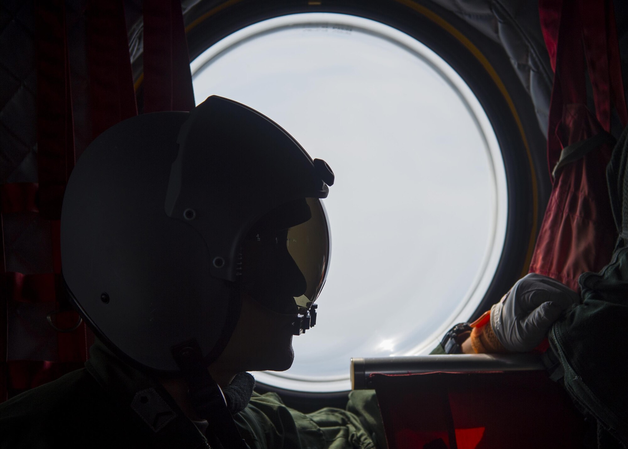 A Japan Air Self-Defense Force CH-47J crew chief assigned to the Air Reserve Wing, Flight Group Misawa Helicopter Airlift Squadron, looks out the window during a flight to Chitose Air Base, Japan, July 21, 2017. The ARW is located at JASDF Iruma Air Base, Japan, near the north of western Tokyo. The CH-47J was providing cargo to Chitose AB, which gave Pacific Air Forces’ F-16 Demonstration Team members the opportunity to use this method of transportation. (U.S. Air Force Staff Sgt. Deana Heitzman)