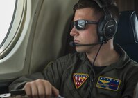 U.S. Navy Petty Officer 2nd Class Morgan Reeves, Naval Air Facility Misawa crewman, looks out the window of a UC-12F Huron during a flight back to Misawa Air Base, Japan, July 24, 2017. In the past, Reeves and his team have transported the Pacific Air Forces’ F-16 Demonstration Team to other U.S. and foreign military bases in Japan and the Republic of Korea. (U.S. Air Force Staff Sgt. Deana Heitzman)