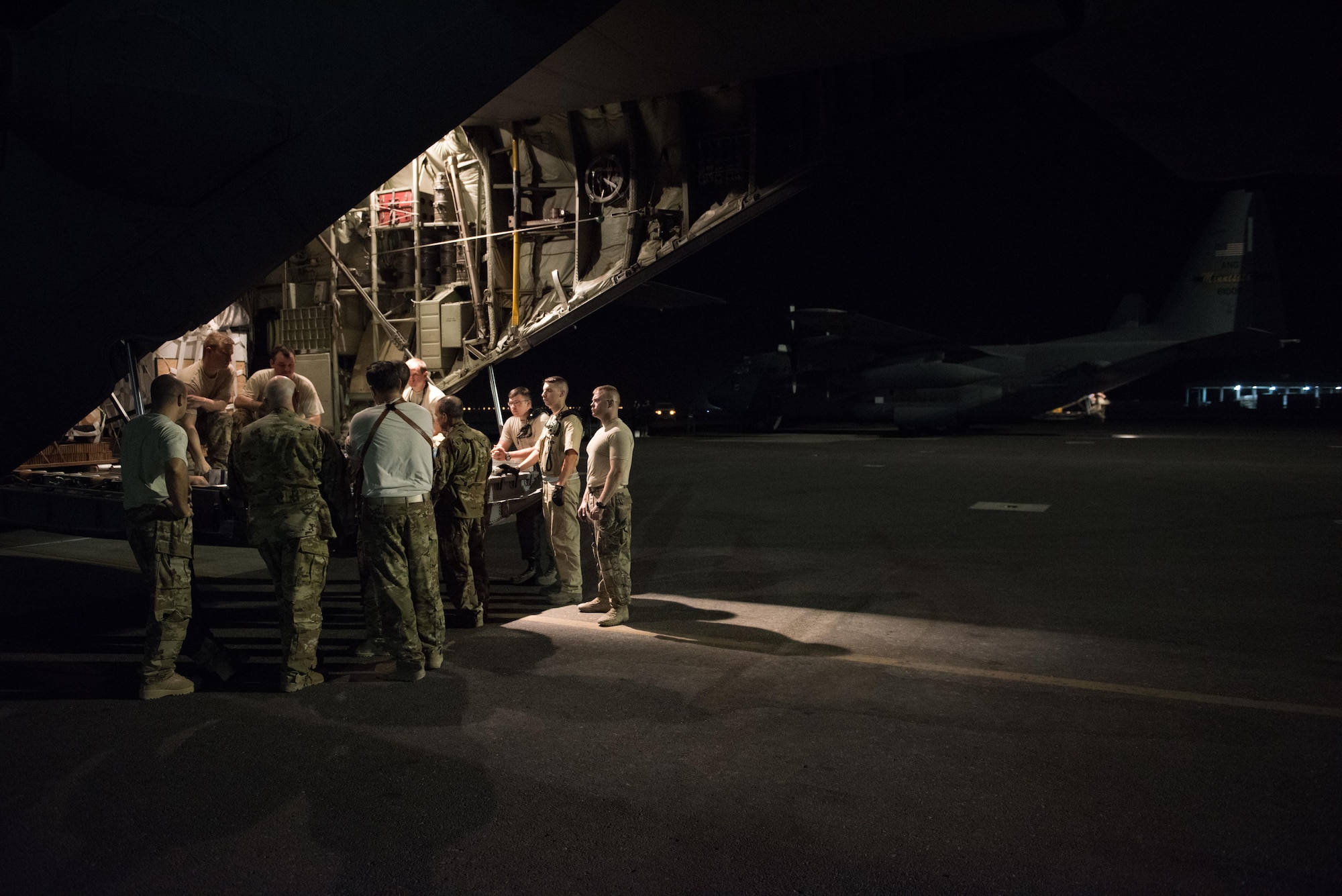 An aircrew assigned to the 737th Expeditionary Airlift Squadron holds a pre-flight brief at the rear of a C-130H Hercules prior to departing on a combat mission at an undisclosed location in Southwest Asia, July 14, 2017. Air National Guardsmen and their aircraft, deployed in support of Combined Joint Task Force – Operation Inherent Resolve, execute daily airlift missions out of one of the busiest air bases in the U.S. Air Forces Central Command area of responsibility. (U.S. Air Force photo by Tech. Sgt.  Jonathan Hehnly)