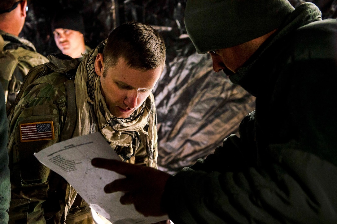 Soldiers discuss training notes during a morning mission brief before participating in a combat training exercise at Fort Hunter Liggett, Calif., July 22, 2017. The soldiers are military police officers. Army Reserve photo by Master Sgt. Michel Sauret