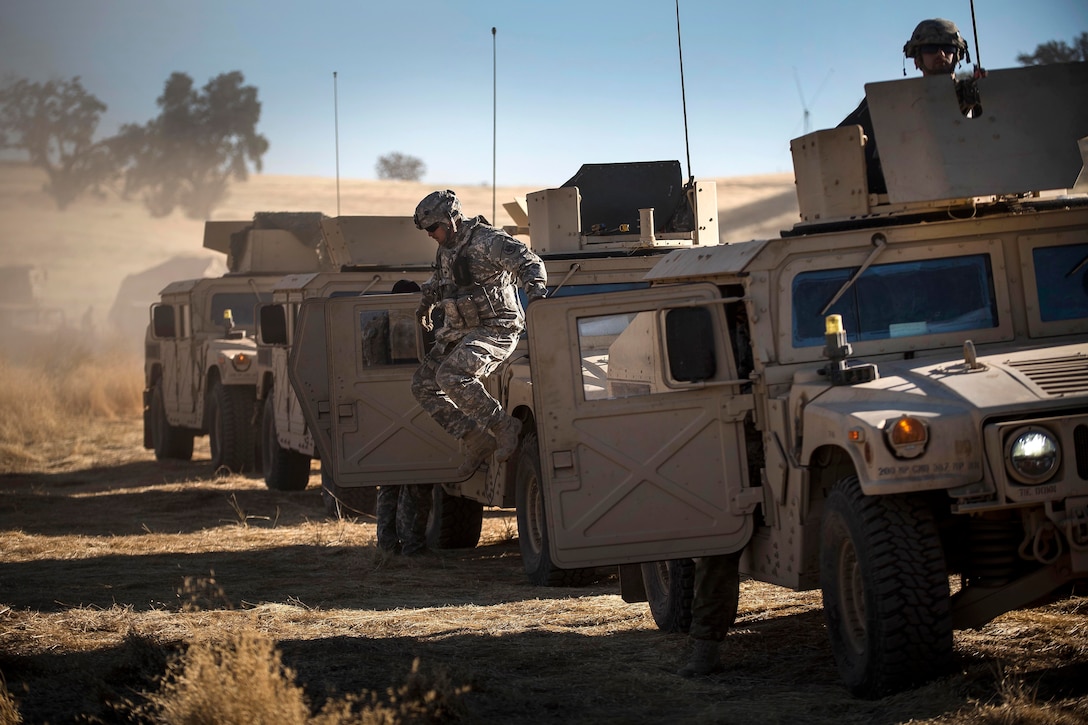 A soldier jumps from a Humvee gunner’s turret during a combat training exercise at Fort Hunter Liggett, Calif., July 22, 2017. Army Reserve photo by Master Sgt. Michel Sauret