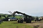 Army Spc. George Flowers, 926th Engineer Brigade, forklifts a concrete mat as part of Resolute Castle 2017 at the Joint National Training Center, Cincu, Romania. DLA-provided materials such as stones, concrete and lumber were used for Resolute Castle 2017 projects. The concrete mat is used as a foundation for roads in wet areas and low-water crossings. 