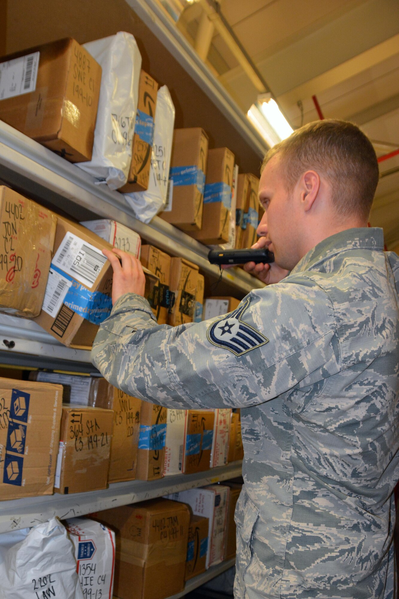 U.S. Air Force Staff Sgt. Douglas Eaton, 100th Communications Squadron Post Office postal clerk, scans a package during training on the new parcel tracking system July 18, 2017, on RAF Mildenhall, England. The new system, scheduled to take effect Aug. 14, will allow email notifications to be sent to customers when their packages have arrived at the post office. (U.S. Air Force photo by Tech. Sgt. Lauren Gleason)
