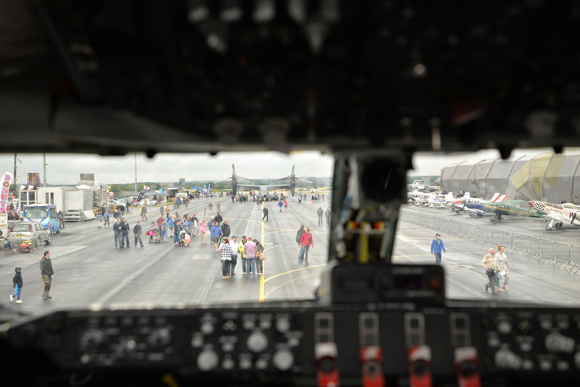 Aircraft and visitors can be seen from the cockpit of a KC-135 Stratotanker July 20, 2017, at the RAF Marham Friends and Families Day event at Marham, England. A CV-22 Osprey and the KC-135, both from RAF Mildenhall, were part of the displays at the event, which included flying displays from a wide variety of aircraft throughout the day. (U.S. Air Force photo by Karen Abeyasekere)