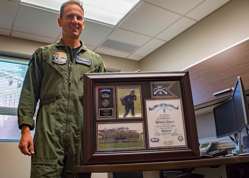 Navy Lt. Joshua Muffett, head of the aviation water survival department at Aviation Survival Training Center Pensacola, Fla., displays a plaque commemorating his graduation from the Army's Basic Airborne Course, July 13, 2017. Muffett attended the three-week class to learn and share parachute training practices. Navy photo by Petty Officer 2nd Class Michael J. Lieberknecht