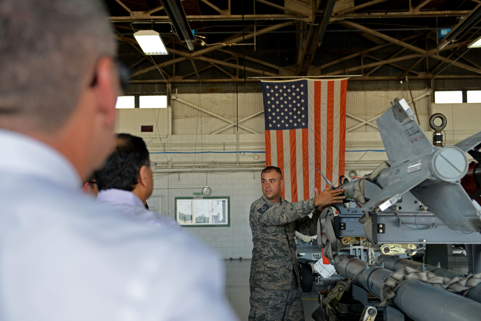 U.S. Air Force Tech. Sgt. Christopher Benton, 20th Maintenance Group weapons academics instructor, speaks about the various munitions the 20th Fighter Wing uses during the McLeod Physician Leadership Academy tour at Shaw Air Force Base, S.C., July 21, 2017. The physicians toured Shaw to learn about how the Air Force builds effective teams and leaders. (U.S. Air Force photo by Airman 1st Class Destinee Sweeney)