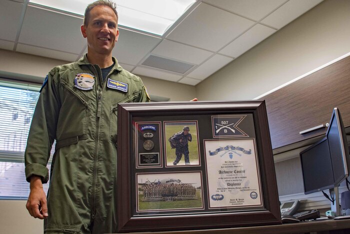 Navy Lt. Joshua Muffett, head of the aviation water survival department at Aviation Survival Training Center Pensacola, Fla., displays a plaque commemorating his graduation from the Army's Basic Airborne Course, July 13, 2017. Muffett attended the three-week class to learn and share parachute training practices. Navy photo by Petty Officer 2nd Class Michael J. Lieberknecht