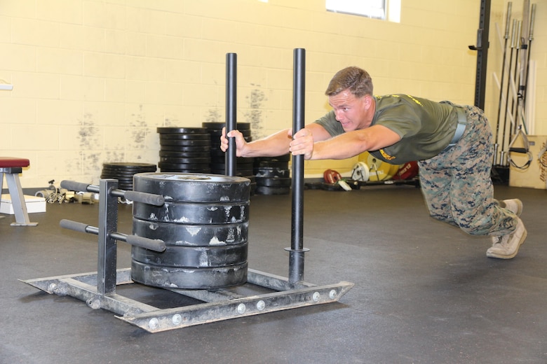 Sgt. Justin Odom, Marine Corps Systems Command training non-commissioned officer, performs a snatch lift July 18, at the High Intensity Tactical Training facility aboard Marine Corps Base Quantico, Virginia. After earning the top male competitor spot in the HITT preliminaries at Quantico, Odom was selected to represent the base in the Third Annual HITT Athlete Championship at Camp Pendleton, California, in August. (U.S. Marine Corps photo by Kaitlin Kelly)