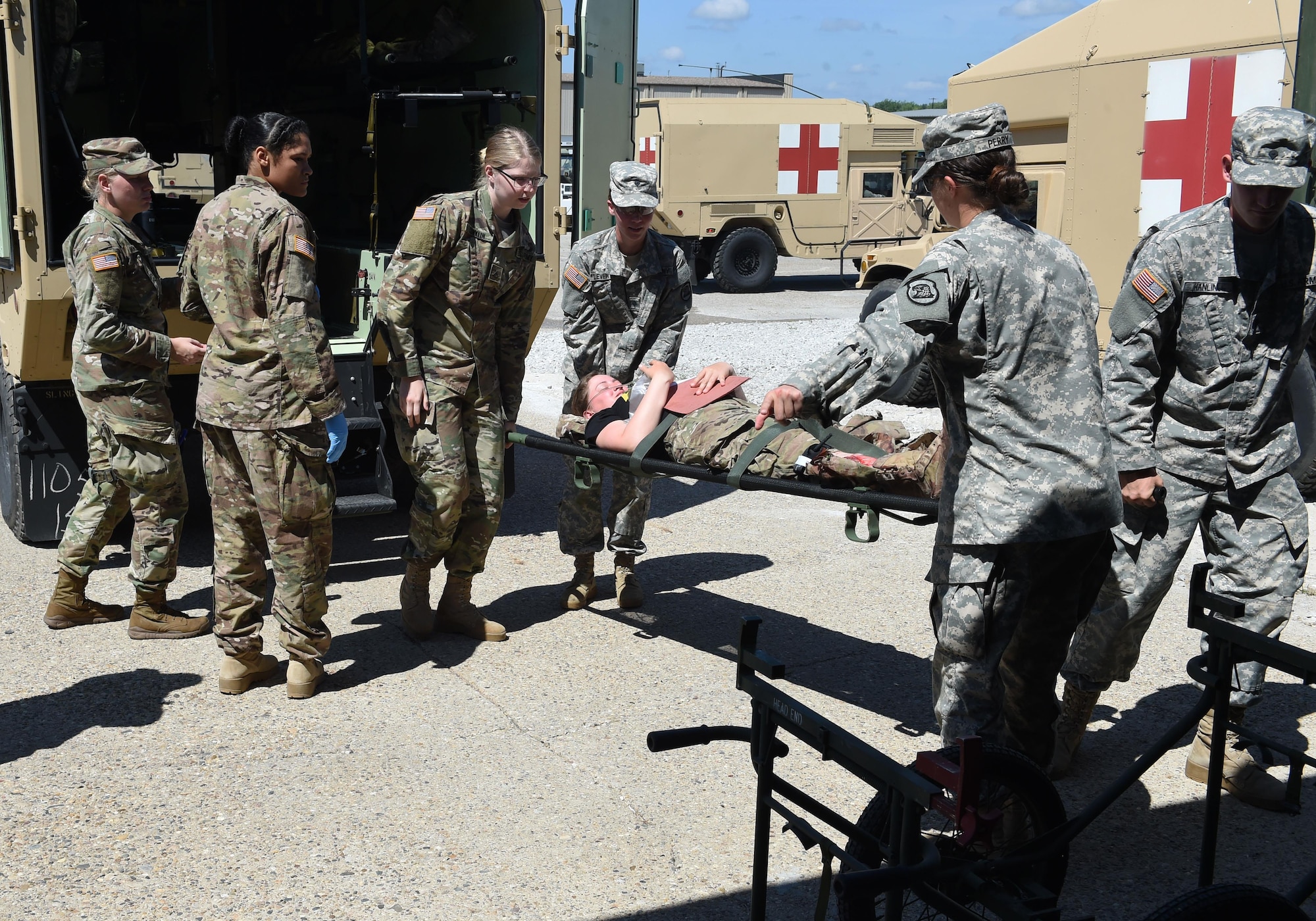 Soldiers from the 209th and 134th Medical Companies practice transfering a patient from an ambulance into the Sustainment Training Center, July 24, 2017, at Camp Dodge in Johnston, Iowa. Medics from the Iowa Air and Army National Guard trained with medics from the United Kingdom and Kosovo. (U.S. Air National Guard photo by Staff Sgt. Michael J. Kelly)
