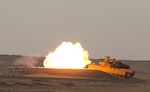 An M1A2 Abrams Main Battle Tank crew engages targets while providing direct fire support for a reconnaissance element during Hunter-Killer training at the Kuwait Multipurpose Range Complex June 7. Saber Squadron is developing Hunter-Killer as a concept, teaming Bradleys up with tanks for increased firepower and speed in the reconnaissance mission. (U.S. Army photo by Staff Sgt. Leah R. Kilpatrick/ released)
