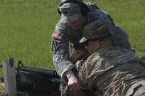 U.S. Army Reserve Staff Sgt. Lisa Presley assists Sgt. Brandon Hubbard during weapons qualification July 22, 2017, Ft. Gordon, Ga. Weapons qualifiication is a yearly event for the reserve soldiers and is part of the Fight Tonight Initiative to improve soldier readiness.