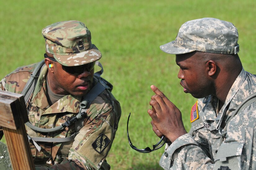 U.S. Army Reserve Spc. Matthew Roberts converses with his coach during weapons qualification July 22, 2017, Ft. Gordon, Ga. Roberts trains monthly to maintain Army standards and to support the Fight Tonight Initiative which is an effort to improve soldier readiness.