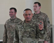Gen. Jose Burgos discusses the history of the 99th Regimental Support Command coin before awarding it to Soldiers of the 314th Press Camp Headquarters. Burgos awarded the coin to noncomissioned officers who exceeded the standard in their area of expertise.