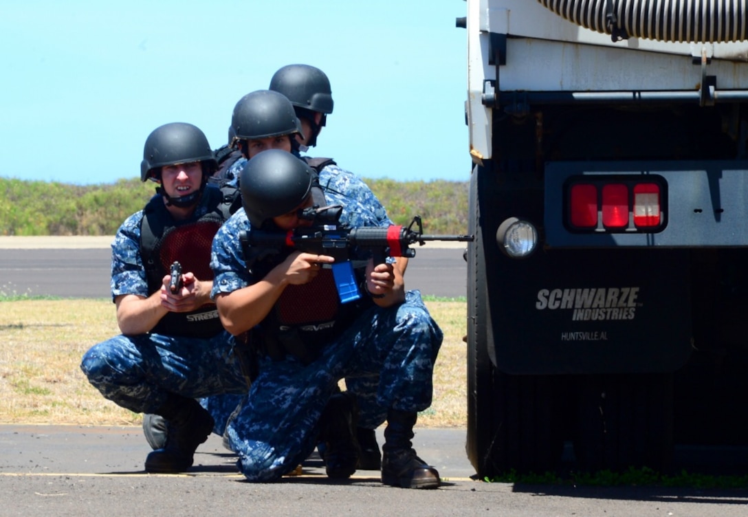 Pacific Missile Range security forces personnel survey the perimeter as they search for suspects during an active shooter exercise conducted in Barking Sands, Hawaii, as part of the annual Citadel Pacific exercise, Aug. 30, 2016. Citadel Pacific's objective is to enhance the training and readiness of security forces and Navy first-responders for specific threats to installations and personnel. Navy photo by Petty Officer 2nd Class Omar-Kareem Powell