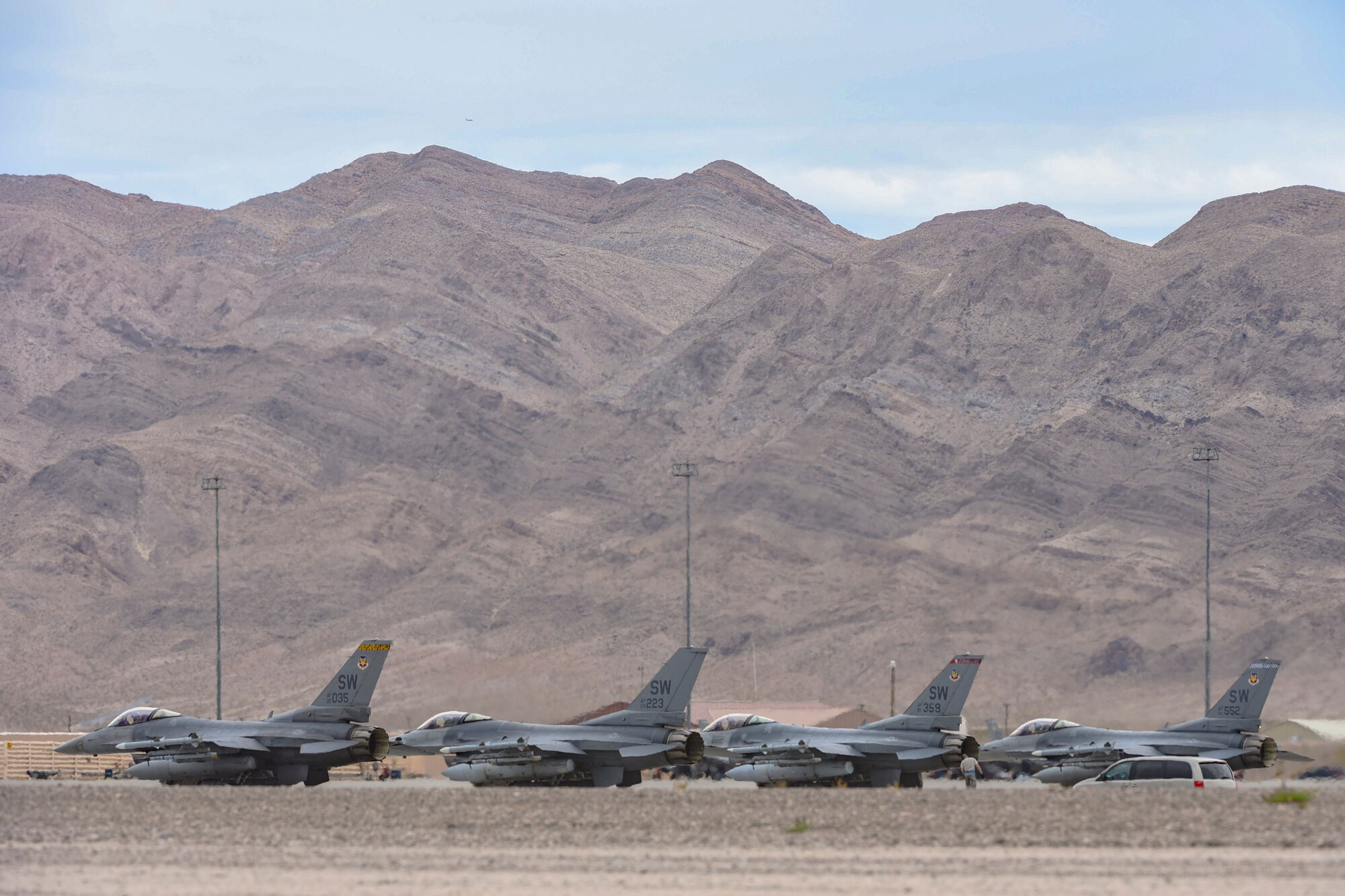 A flight of four F-16 Fighting Falcons from the 55th Fighter Squadron, Shaw Air Force Base, S.C., perform their pre-flight checks before taking off from Nellis Air Force Base, Nev., to participate in Red Flag 17-3 July 24, 2017. The F-16 is a highly maneuverable, multi-role fighter aircraft. (U.S. Air Force photo by Airman 1st Class Andrew D. Sarver/Released)