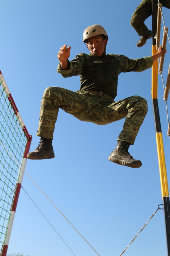 A Mexican competitior drops 15  feet off a ladder during the grueling obstacle course event as part of Fuerzas Comando July 24, 2017, at Vista Alegre, Presidente Hayes, Paraguay. Team Mexico placed third in the event. Special operations personnel from 20 countries participated in the Fuerzas Comando competition, which is designed to improve training, readiness, interoperability, and capability. (U.S. Army photo by Staff Sgt. Chad Menegay/Released)