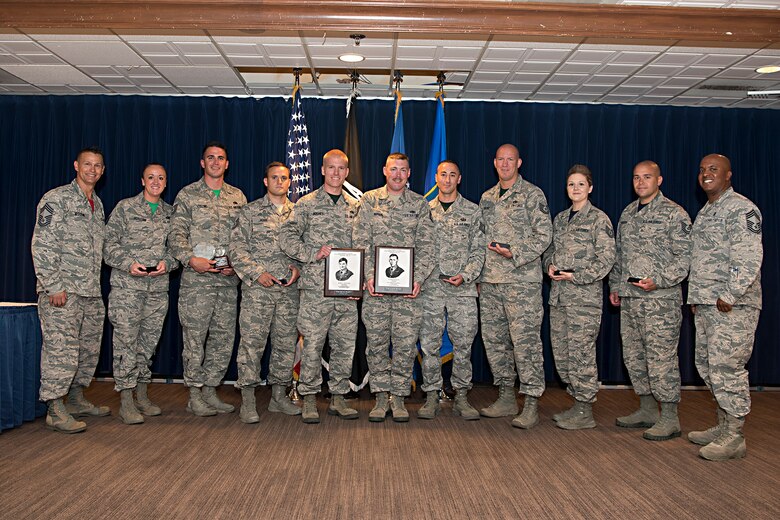 PETERSON AIR FORCE BASE, Colo. – Chief Master Sgt. Robert Woodin, Forrest L. Vosler Non-Commissioned Officer Academy commandant (far left), and Chief Master Sgt. Kelbey Norton, 21st Medical Group superintendent (far right), stand with award winners from the VNCOA graduation breakfast at Peterson Air Force Base, Colo., July 21, 2017. The graduation breakfast is held at the end of every five week VNCOA course and it is where outstanding course attendees and students can be recognized. (U.S. Air Force photo by Steve Kotecki)
