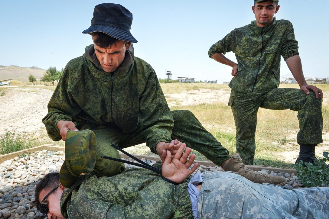 Tajik service members perform search-and-detain scenarios during a field training exercise that's part of multinational exercise Regional Cooperation 2017 in Fakhrabad, Tajikistan, July 17, 2017. Air Force photo by Staff Sgt. Michael Battles