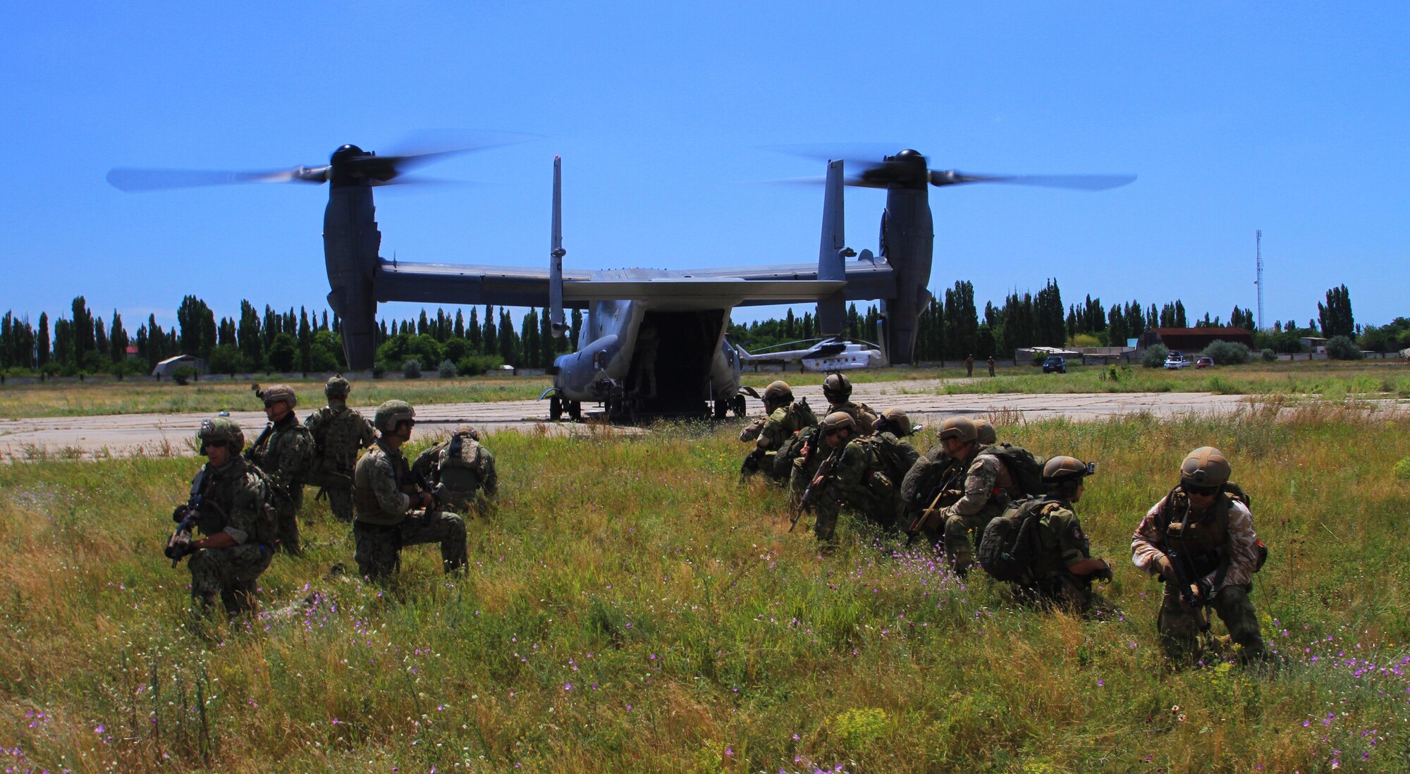 A combined U.S. and Ukrainian team of Special Operation Forces wait to board a CV-22 Osprey during air movement training in Ukraine, July 14, 2017.  Sea Breeze is a U.S. and Ukraine co-hosted multinational maritime exercise held in the Black Sea and is designed to enhance interoperability of participating nations and strengthen maritime security within the region.
