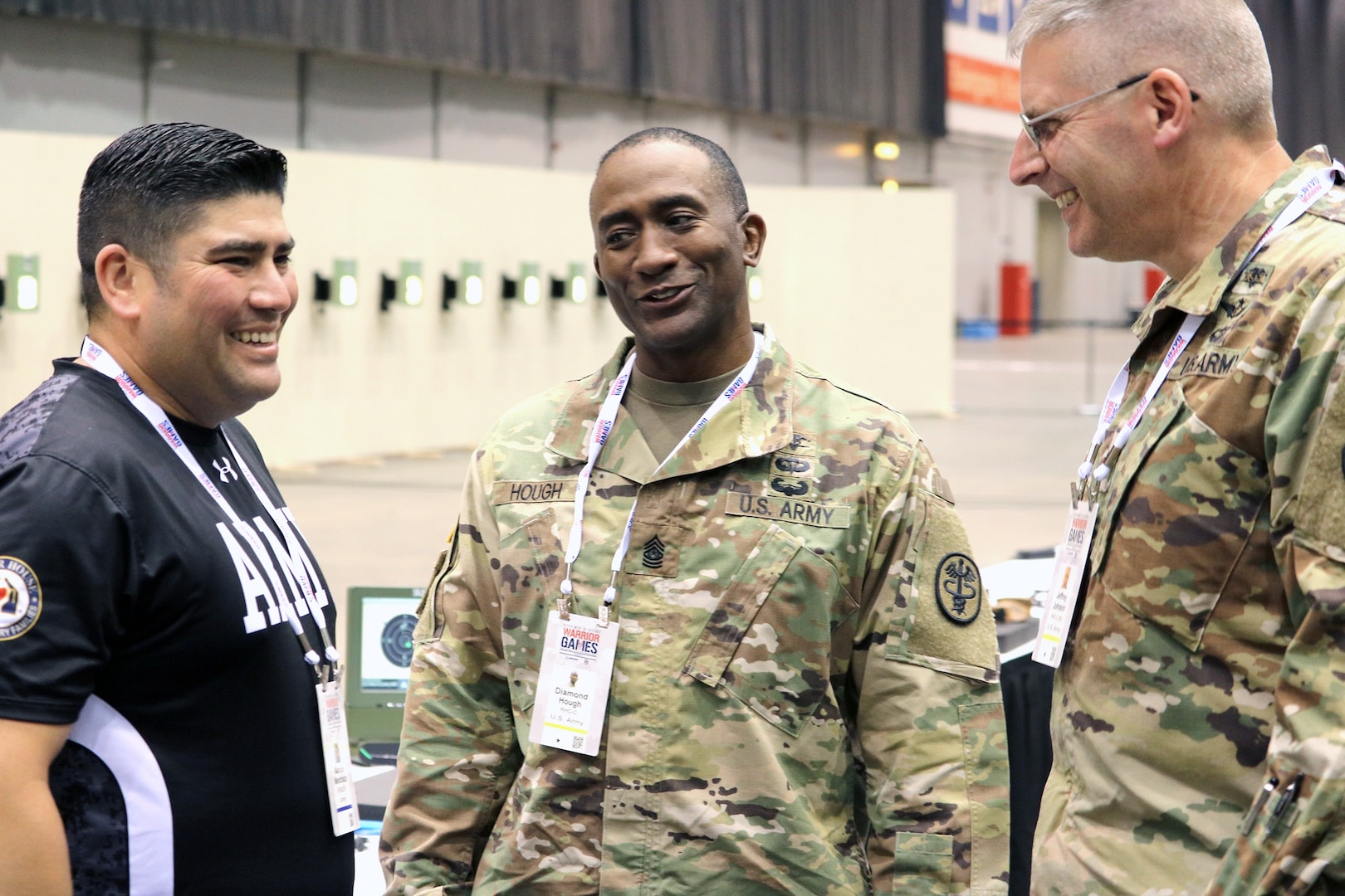 U.S. Army Staff Sgt. Marcus Menchaca (left), Warrior Transition Battalion, Brooke Army Medical Center, is congratulated by BAMC Command Sgt. Maj. Diamond Hough (center) and BAMC Commander Brig. Gen. Jeffrey Johnson (right) after winning the bronze medal in the air pistol competition July 6, at McCormick Place Convention Center, Chicago, Ill., during the 2017 Department of Defense Warrior Games. The DoD Warrior Games are an adaptive sports competition for wounded, ill and injured service members and veterans. Approximately 265 athletes representing teams from the Army, Marine Corps, Navy, Air Force, Special Operations Command, United Kingdom Armed Forces and the Australian Defence Force competed June 30 – July 8 in archery, cycling, track, field, shooting, sitting volleyball, swimming and wheelchair basketball.