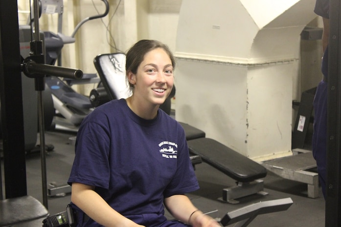 Ensign Abigail Isaacs prepares to lead training on donning life-saving fire fighting equipment.