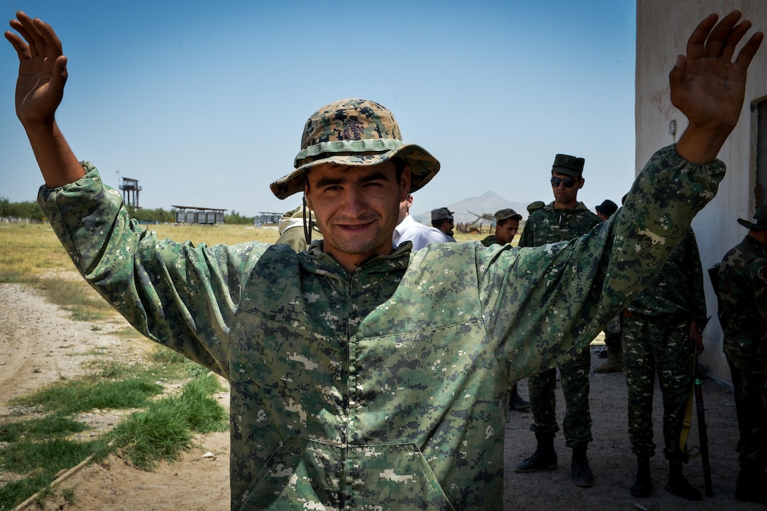 A Tajik service member prepares to be searched during a field training exercise that's part of multinational exercise Regional Cooperation 2017 in Fakhrabad, Tajikistan, July 17, 2017. Air Force photo by Staff Sgt. Michael Battles

