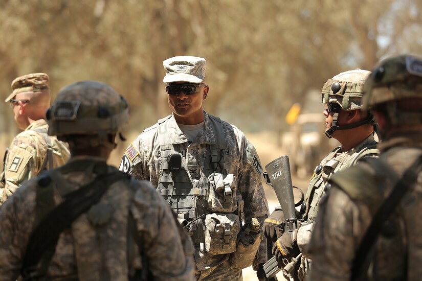 Col. Flint Patterson, center, commander of the 4th Cavalry Multi-Functional Training Brigade, First Army Division East, meets with Army Reserve Soldiers assigned to the 208th Transportation (Palletized Loading System) Company, based in Marana, Arizona, during Combat Support Training Exercise 91-17-03, July 18, 2017, at Fort Hunter Liggett, Calif. Approximately 5,000 Army Reserve and National Guard forces participated in the exercise. First Army provided about 65 observer coach/trainers to augment their Army Reserve partners at the 91st Training Division and assist in training the most capable, combat-ready and lethal federal reserve force in the history of the nation. 
(U.S. Army photo by Master Sgt. Anthony L. Taylor)