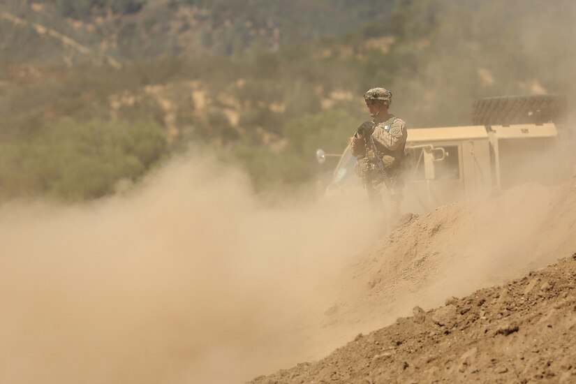 U.S. Army Reserve Sgt. John Brownlee, a Horizontal Construction Engineer assigned to the 718th Engineer Company, based in Fort Benning, Ga., is covered in a cloud of smoke while overseeing operations to improve a berm for a fuel blivet, a collapsible tank, emplacement during Combat Support Training Exercise 91-17-03, July 18, 2017, at Fort Hunter Liggett, Calif. Approximately 5,000 Army Reserve and National Guard forces participated in the exercise. First Army provided about 65 observer coach/trainers to augment their Army Reserve partners at the 91st Training Division and assist in training the most capable, combat-ready and lethal federal reserve force in the history of the nation. 
(U.S. Army photo by Master Sgt. Anthony L. Taylor)