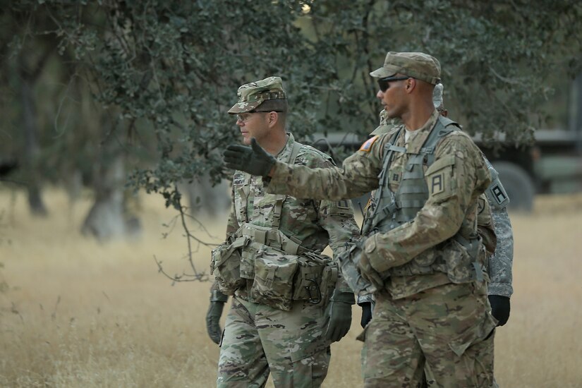 Capt. Elijah Murrell, right, of the Army Reserve’s 3rd Battalion, 383rd Regiment, 4th CAV MFTB in St. Louis, Mo., and lead observer coach/trainer for the 208th Transportation (Palletized Loading System) Company, briefs Maj. Gen. Todd McCaffrey, commanding general of First Army Division East, during a battlefield circulation review of Combat Support Training Exercise 91-17-03, July 18, 2017, at Fort Hunter Liggett, Calif. The 208th Transportation Company is an Army Early Response Force unit that must be ready to deploy with very short notice. Approximately 5,000 Army Reserve and National Guard forces participated in the exercise. First Army provided about 65 observer coach/trainers to augment their Army Reserve partners at the 91st Training Division and assist in training the most capable, combat-ready and lethal federal reserve force in the history of the nation. 
(U.S. Army photo by Master Sgt. Anthony L. Taylor)