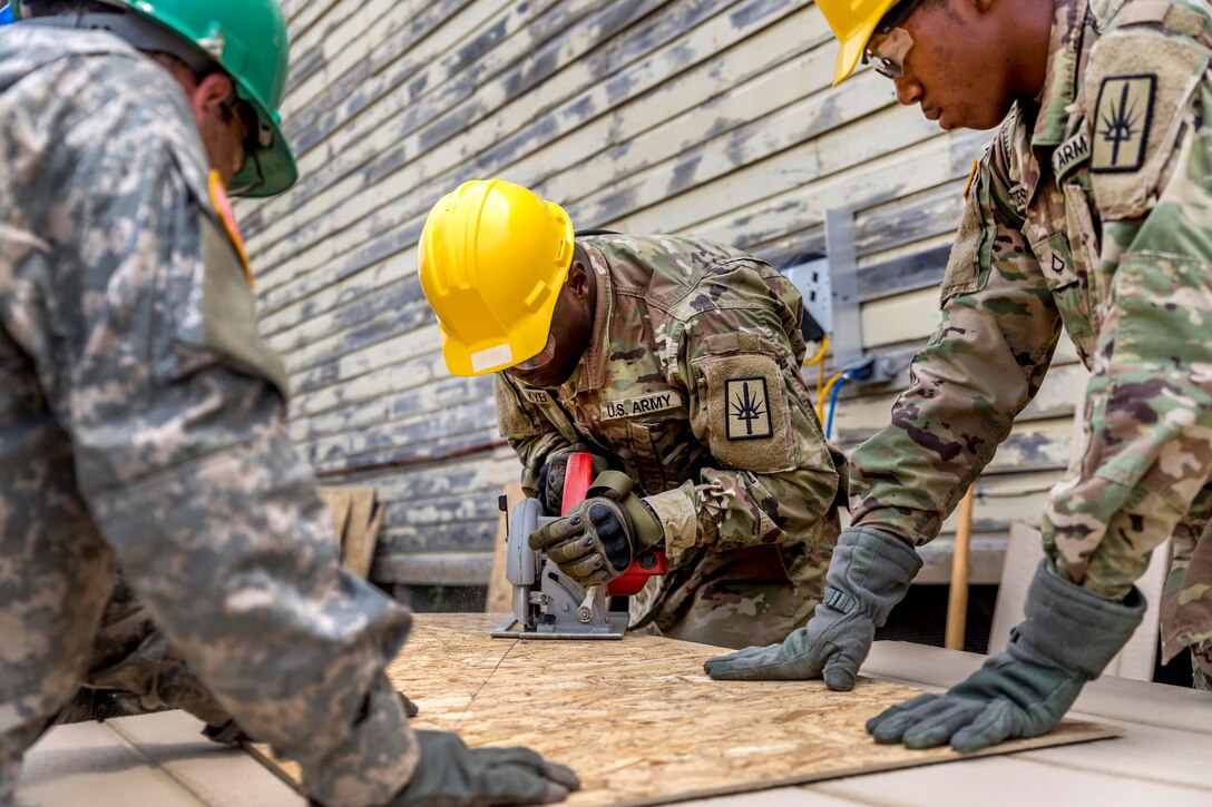 New York Army National Guard Spc. Kyei cuts lumber for one of two shed construction projects during his unit's annual training at Fort Drum, N.Y., July 19, 2017. Kyei is assigned to the New York Army National Guard’s 1156th Engineer Company, 204th Engineer Battalion. Army National Guard photo by Sgt. Harley Jelis 