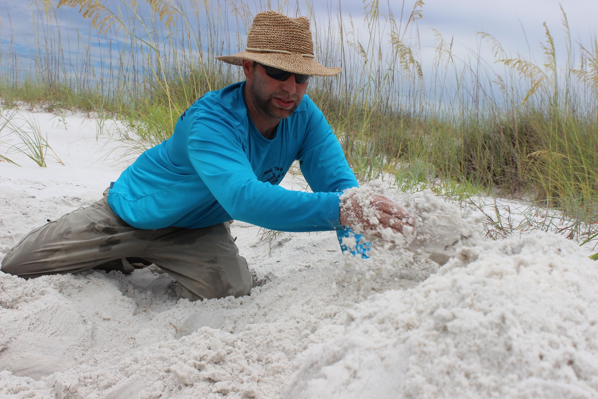 Jared Kwitowski, a 325th Civil Engineer Squadron Natural Resources Wildlife Biologist, processes a potential Green Sea Turtle nest July 12 on the Tyndall Air Force Base, Florida, beach. The Tyndall natural resources office helps protect these endangered sea turtles during the hatching process to ensure their survival. The Air Force Civil Engineer Center’s Eglin Installation Support Section helps bases in the Florida Panhandle identify requirements and develop permits and plans to execute environmental and civil engineering projects. (U.S. Air Force photo/Shannon Carabajal)