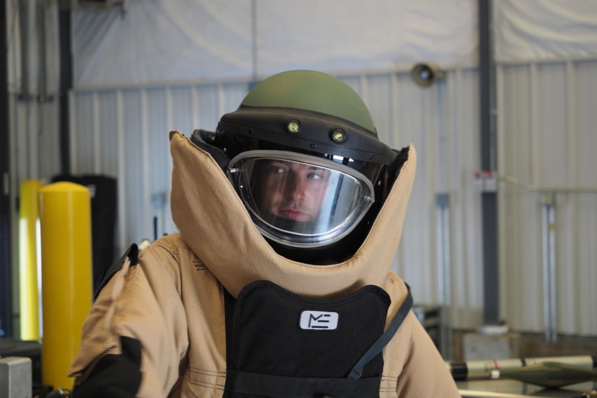 Honorary Commander Brad Ingber tries on a bomb suit. (Air Force Photo/Paul Zadach)