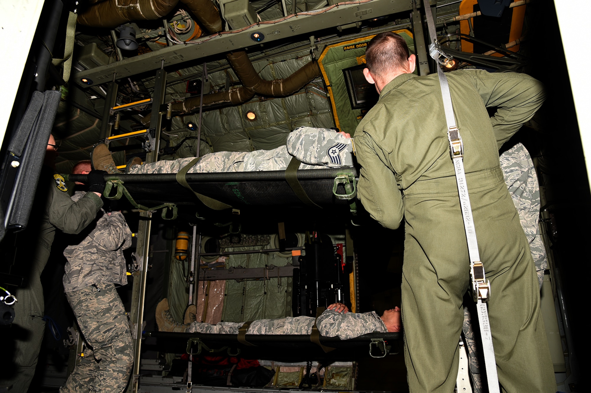 PETERSON AIR FORCE BASE, Colo. – The 21st Medical Group, along with the 302nd Airlift Wing, conducted joint training with Airmen from the U.S. Air Force Academy and Schriever Air Force Base to conduct a proper loading and for casualties in a training exercise onboard a C-130 Hercules aircraft, July 14, 2017 at Peterson AFB, Colorado. The C-130 can hold up to 74 passengers for transport to medical facilities around the world. (U.S. Air Force photo by Robb Lingley)