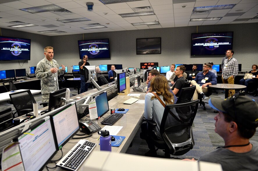 Capt. Paul Karsten (left), 4th Space Operations Squadron deployment commander, briefs Hollywood tour participants on different aspects of the space mission at Schriever Air Force Base, Colorado, July 17, 2017. The Hollywood directors, writers and producers used the tour to gain information of the not only the military, but specifically the Air Force and how they support the space mission. (U.S. Air Force photo/Dennis Rogers)