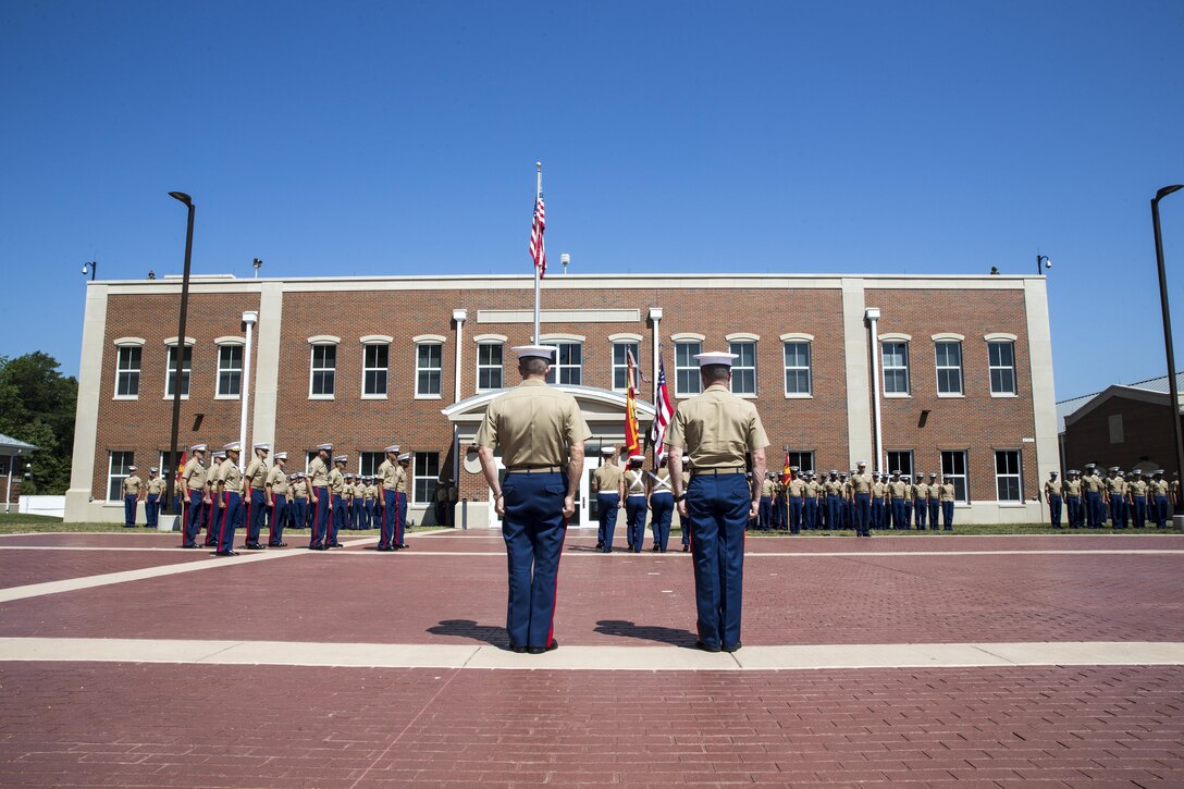 U.S. Marine Corps Col. Rod Brewster, left, outgoing commanding officer for Marine Corps Embassy Security Group (MCESG), and Col. Michael C. Taylor, company commander for MCESG, stand at attention during Brewster’s retirement ceremony at Marine Corps Base Quantico, Va., July 19, 2017. Brewster served 25 honorable years in the U.S. Marine Corps. (U.S. Marine Corps photo by: Lance Cpl. Cristian L. Ricardo)