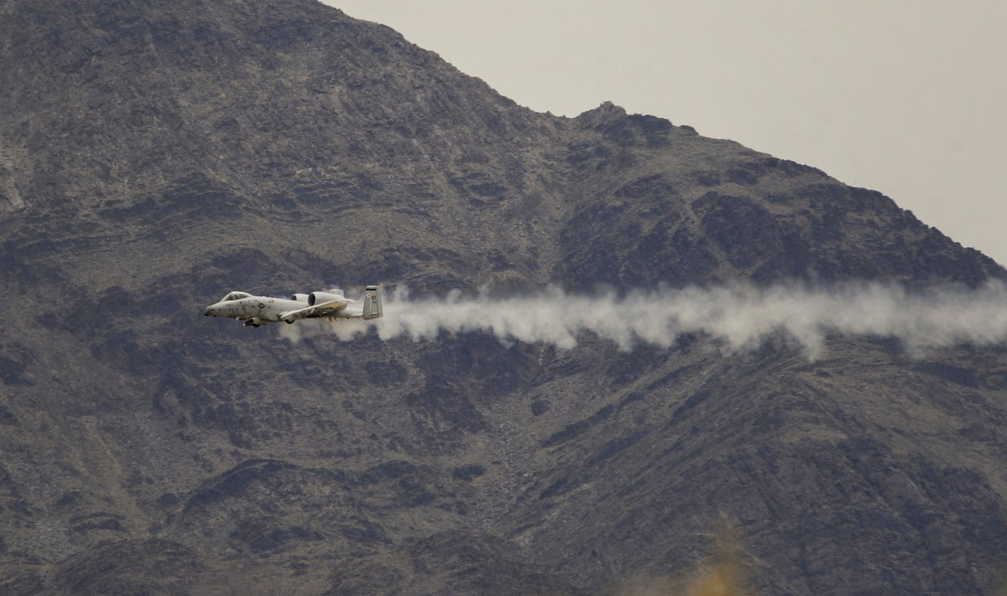 An A-10 Thunderbolt II attack aircraft fires a rotary cannon during a training exercise on the Nevada Test and Training Range July 19, 2017. The A-10 has excellent maneuverability at low air speeds and altitude, and is a highly accurate and survivable weapons-delivery platform. (U.S. Air Force photo by Senior Airman Kevin Tanenbaum/Released)