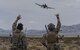 Joint terminal attack controllers wave at an A-10 Thunderbolt II attack aircraft during a show of force on the Nevada Test and Training Range July 19, 2017. The A-10 has excellent maneuverability at low air speeds and low-altitude, and is a highly accurate weapons delivery platform. (U.S. Air Force photo by Senior Airman Kevin Tanenbaum/Released)