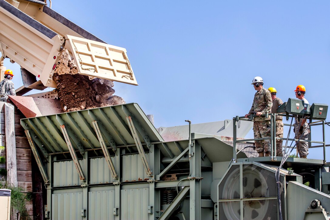 New York Army National Guardsmen watch as boulders and dirt are loaded into a quarry crusher supporting other units with material during annual training at Fort Drum, N.Y., July 20th, 2017. Army National Guard photo by Sgt. Harley Jelis