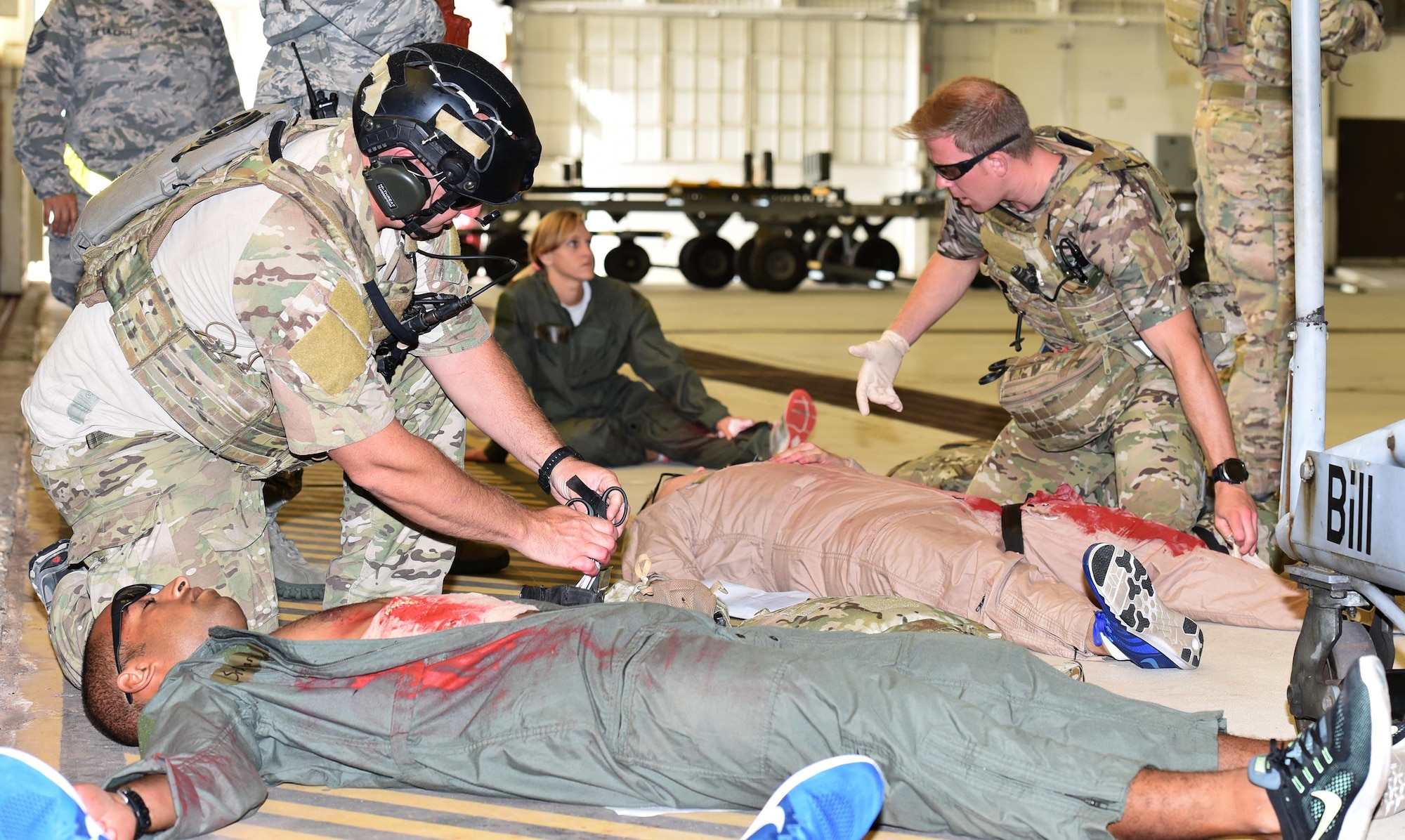 Master Sgt. Louis Hause, left, and Staff Sgt. Lucus Vannorsdall, right, 308th Rescue Squadron pararescuemen, tend to victims of an active shooter exercise July 25, 2017 in Hangar 750. The pararescuemen were the first medics to arrive on scene, followed by the 45th Civil Engineer Squadron firefighters who took command of the scene. The first responders worked side-by-side to attend to victims and load them into ambulances for transport to the hospital.  The exercise was a joint endeavor between the host 45th Space Wing and 920th Rescue Wing. (U.S. Air Force photo/Tech. Sgt. Lindsey Maurice)