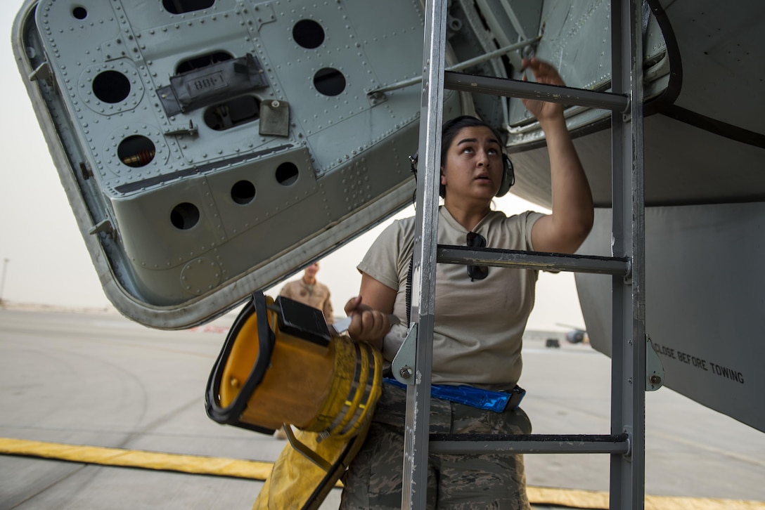 An airman assigned to the 379th Expeditionary Aircraft Maintenance Squadron prepares an air conditioning unit before preflight checks on a KC-135 Stratotanker aircraft on Al Udeid Air Base, Qatar, July 18, 2017. Air Force photo by Staff Sgt. Trevor T. McBride