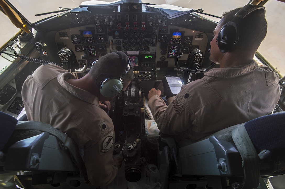 Two KC-135 Stratotanker aircraft pilots perform preflight checks in support of Operation Inherent Resolve on Al Udeid Air Base, Qatar, July 18, 2017. The KC-135, a refueling aircraft, assists U.S. and coalition aircraft to deliver decisive airpower as part of the campaign to destroy the Islamic State of Iraq and Syria. Air Force photo by Staff Sgt. Trevor T. McBride