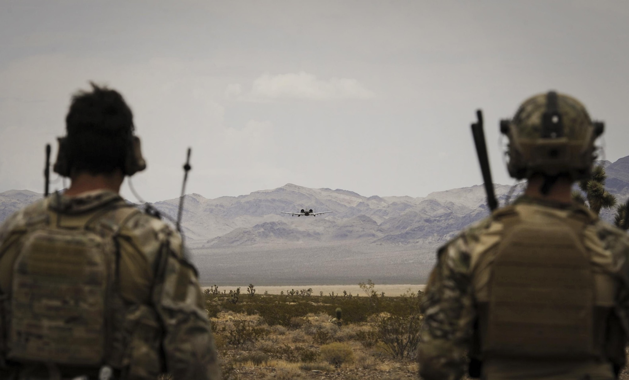 Joint terminal attack controllers watch an A-10 Thunderbolt II attack aircraft during a show of force on the Nevada Test and Training Range July 19, 2017. The A-10s wide combat radius, and short takeoff and landing capability permit operations in and out of locations near front lines. (U.S. Air Force photo by Senior Airman Kevin Tanenbaum/Released)