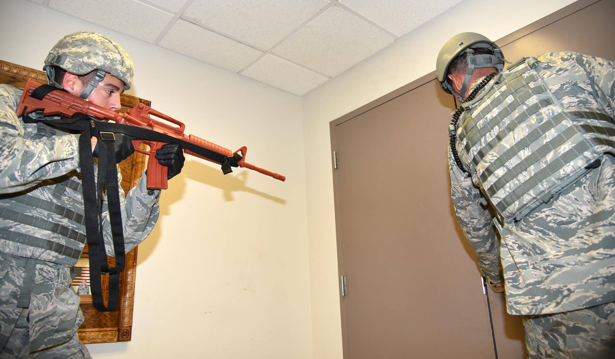 Senior Airman Bryan Tremaine, left, and Staff Sgt. Stefan Laufenberg, 45th Security Forces Squadron defenders, clear and secure Hangar 750 during a joint active shooter exercise July 25, 2017 between the 920th Rescue Wing and 45th Space Wing. The security forces team was the first to respond to the scene, where they immediately apprehended the shooter and cleared the building for medical teams to safely tend to the victims. (U.S. Air Force photo/Tech. Sgt. Lindsey Maurice)